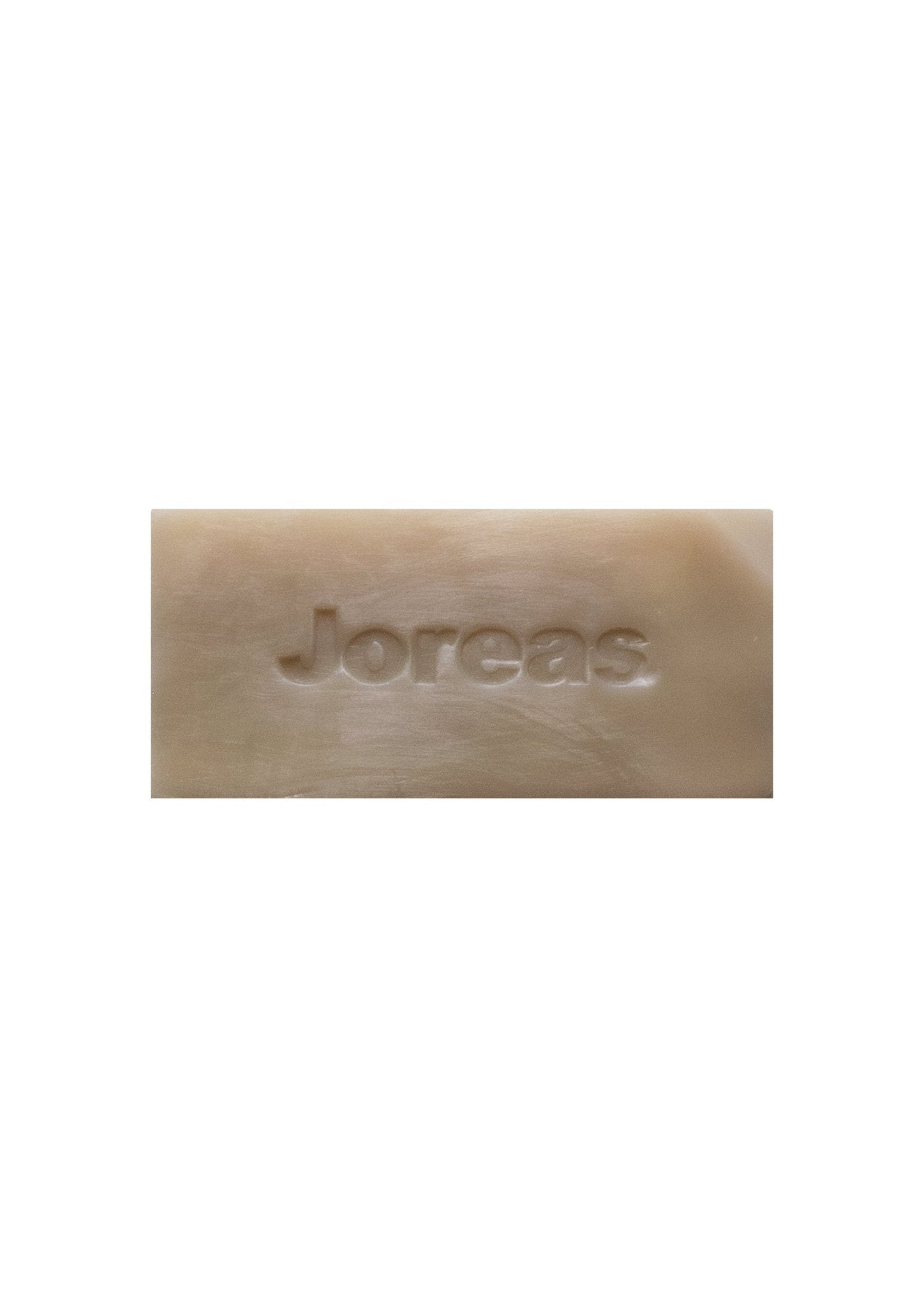 Beige rectangular bar soap with embossed text on white background