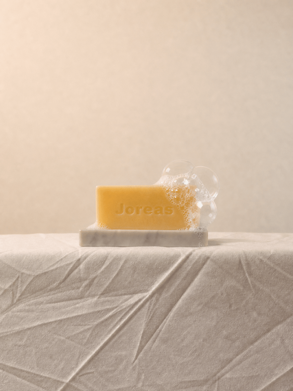 Cherish Milk Bar displayed on a minimalist natural stone soap dish