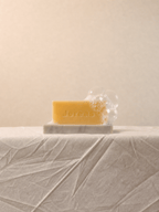 Cherish Milk Bar displayed on a minimalist natural stone soap dish