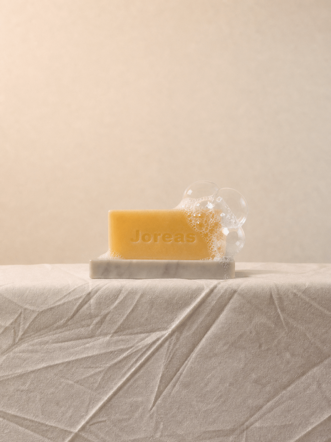 Cherish Milk Bar displayed on a minimalist natural stone soap dish
